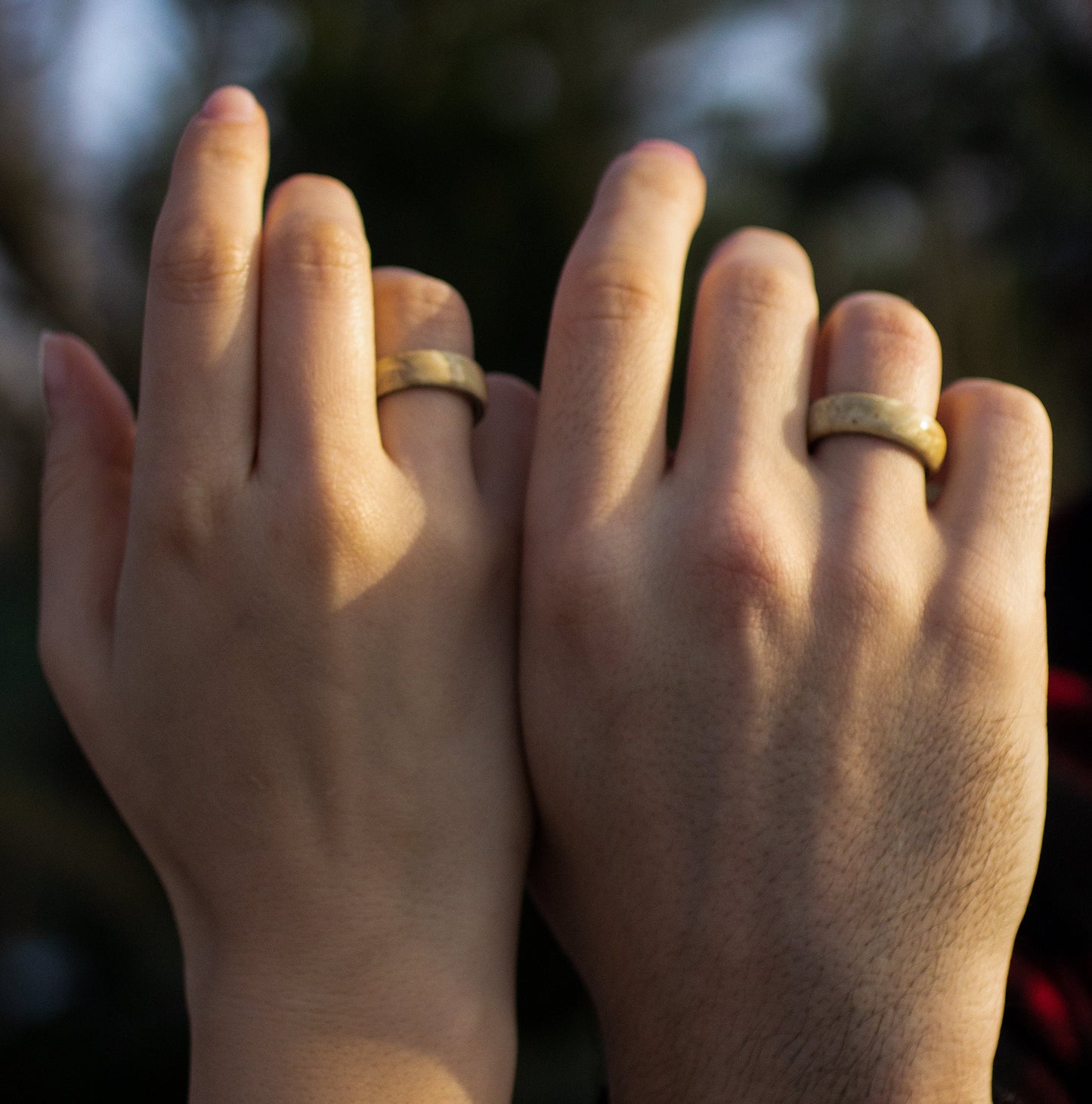 Couple wearing matching Andrwood Maple Wood Rings with Stainless Steel Core, symbolizing unity and love in a natural style.