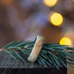 Andrwood Maple Wood Ring with Stainless Steel Core resting on pine branch, ideal for nature-inspired wedding or engagement rings.